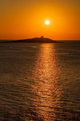 an orange sunset over a body of water at Ciuri Ciuri in Isola delle Femmine