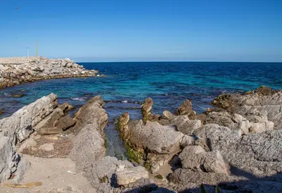 a group of rocks on the shore of the ocean at Ciuri Ciuri in Isola delle Femmine