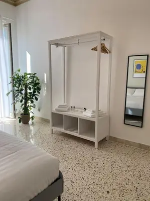 a white bedroom with a bed and a mirror at Orethus Apartment - Exclusive Palermo Center in Palermo