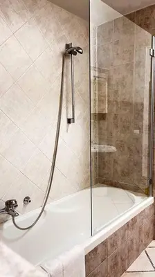 a bathroom with a shower with a white tub at Orethus Apartment - Exclusive Palermo Center in Palermo