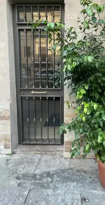 a door with a black gate on a building at GREENHOME in Palermo