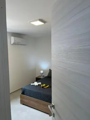 a bedroom with a bed in a room with a door at La Terrazza sul Golfo in Castellammare del Golfo