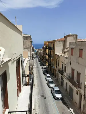 a city street with cars parked on the side at Lovely apartment in Castellammare del Golfo in Castellammare del Golfo