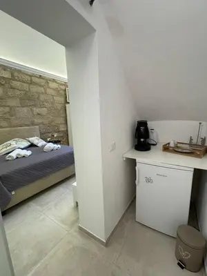 a small bedroom with a bed and a counter at Casa Chiara in Isola delle Femmine