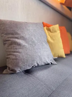 a pillow sitting on a bed with other pillows at Giorgia House Boat in Palermo