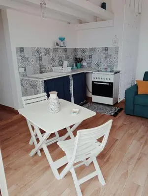a white table and chairs in a living room at Da Carmen e Peppe in Santa Flavia