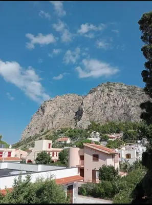 a mountain in the background of a city with buildings at Da Carmen e Peppe in Santa Flavia
