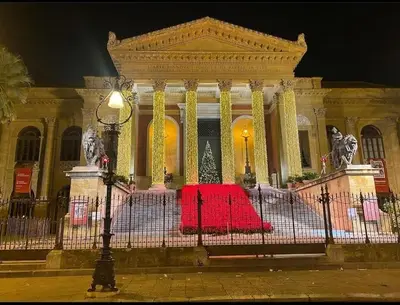 a building with a red table in front of it at Raggio di sole in Ashur in Palermo