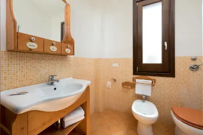 a bathroom with a sink and a toilet at Casa Vacanza Azzurra 4 in San Vito lo Capo
