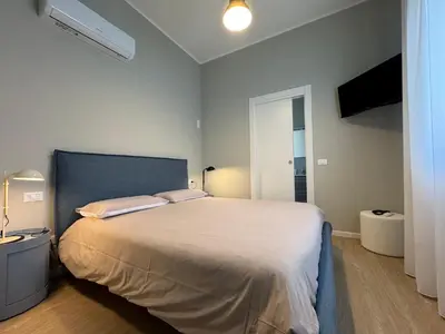 a bedroom with a large bed in a room at Turums B&B in Castellammare del Golfo
