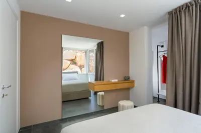a hotel room with a bed and a mirror at La Dolce Vita in Castellammare del Golfo