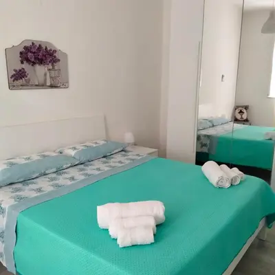 a room with two beds with towels on them at Casa Vacanze L'Ortensia in Bagheria