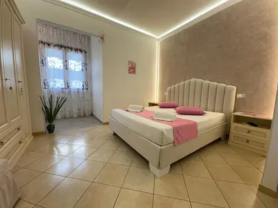 a bedroom with a large bed and a window at B&B Le Ortensie in San Vito lo Capo