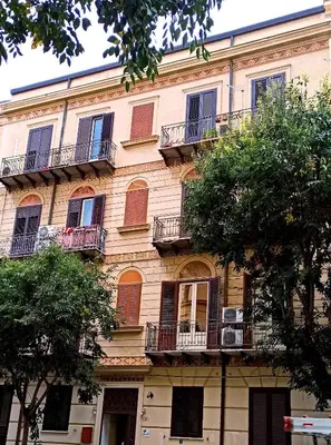 a tall building with balconies and windows on it at Liberty Casa Mazzini 34 in Palermo