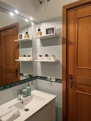 a bathroom with a sink and a mirror at Liberty Casa Mazzini 34 in Palermo