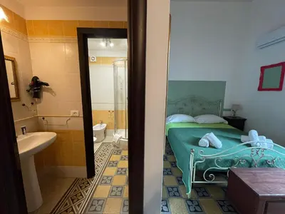 a bedroom with a bed and a potted plant at Teatro del Sole Cavour in Palermo