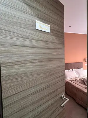 a door to a bedroom with a sign on the wall at Sant’Agostino Boutique Rooms in Palermo