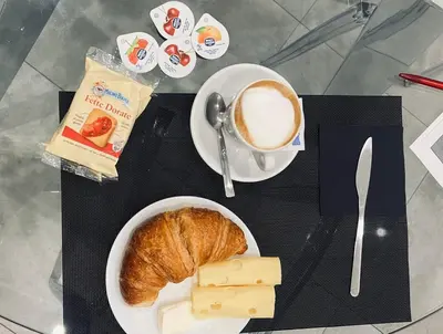 a table with a plate of bread and a cup of coffee at Sant’Agostino Boutique Rooms in Palermo