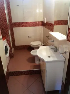 a bathroom with a white toilet and a sink at Purple House a Castellammare del Golfo in Castellammare del Golfo