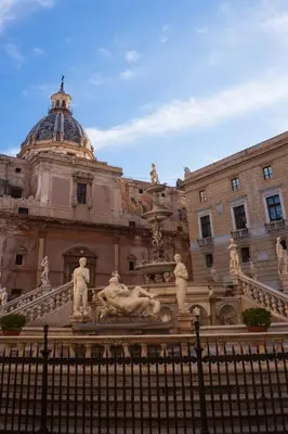 a large building with a fountain in front of it at Hostel Centro Città Basement in Palermo