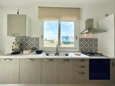 a kitchen with a sink and a window at Meravigghia in Terrasini