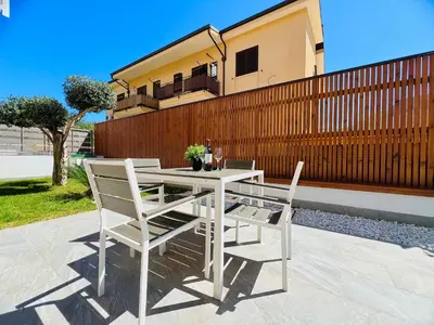 a white table and two chairs on a patio at Meravigghia in Terrasini