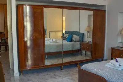 a bedroom with a large wooden dresser with a mirror at Materesa in Palermo