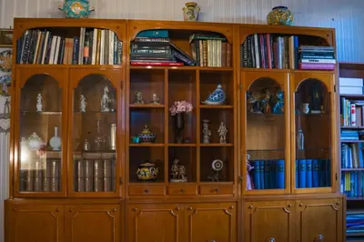 a large wooden book shelf with vases and books at Materesa in Palermo