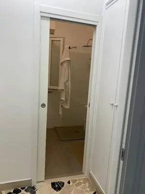 a bathroom with a door leading to a closet at Holiday & House - Imparato Carini Costa Verde - Appartamento con giardino privato - porzione di Villa residenziale a pochi passi dal mare in Carini