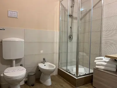 a bathroom with a shower and a toilet and a sink at I Quattru Vuci Rooms in Palermo
