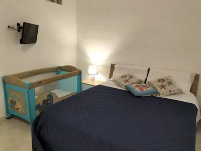 a bedroom with a blue bed with pillows on it at InCentro Palermo in Palermo