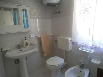 a small bathroom with a toilet and a sink at Bilocale Piano Base Climatizzata in Castellammare del Golfo