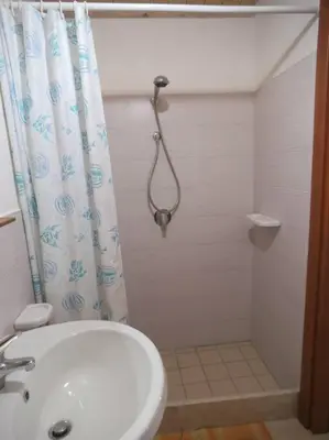 a bathroom with a shower curtain and a sink at Bilocale MoDerna PT in Castellammare del Golfo