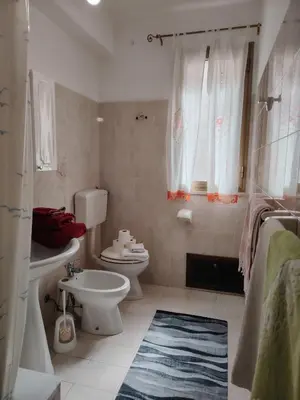 a white bathroom with a toilet and a sink at DernaFlat 15 Climatizzata in Castellammare del Golfo
