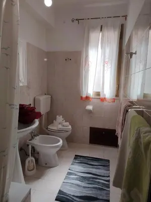 a white bathroom with a toilet and a sink at DernaFlat 15 Climatizzata in Castellammare del Golfo