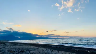 a sunset on the beach with the ocean at Villa Portofino - Private pool in Campofelice di Roccella