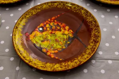 a plate with a picture of a bird on it at Amaryllis Apartments in Bagheria