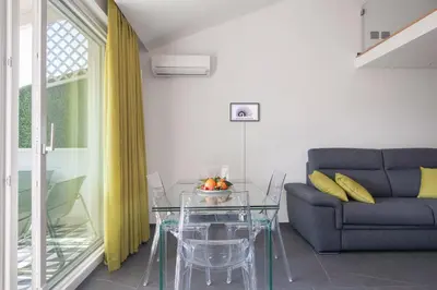 a living room with a glass table and a couch at Archimedes luxury apartment with terrace in Palermo
