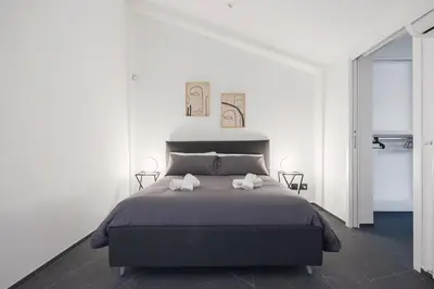 a bedroom with a bed with two towels on it at Archimedes luxury apartment with terrace in Palermo