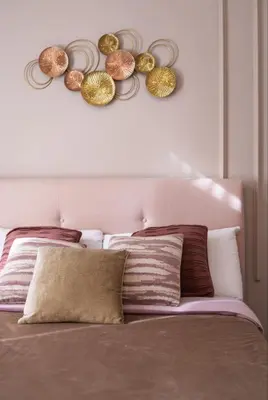 a bed with a bunch of plates on the wall at Doma in Palermo