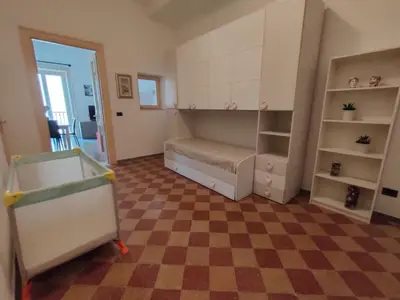 a room with a bed and a checkered floor at Casa Lia al centro di palermo in Palermo