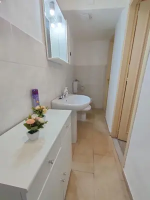 a white bathroom with a sink and a toilet at Casa Lia al centro di palermo in Palermo