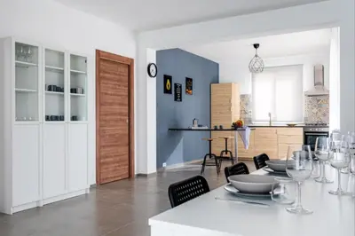 a dining room and kitchen with a table and chairs at Villa Sikania Seaview Scopello in Castellammare del Golfo
