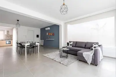 a living room with a couch and a table at Villa Sikania Seaview Scopello in Castellammare del Golfo