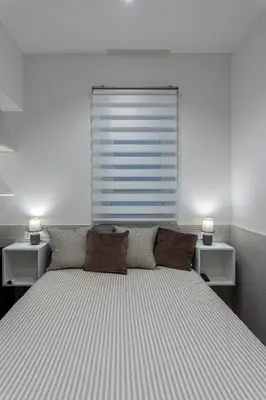 a bedroom with a large bed with two night stands at OLIVUZZA TOWER in Palermo