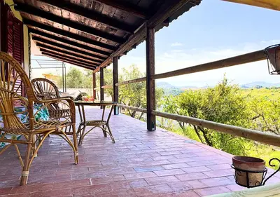 a patio with chairs and a table on a porch at Villa Finestra sul Castello in Partinico