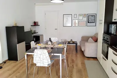 a dining table and chairs in a living room at Casa Phimes in Calatafimi
