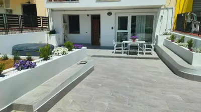 a patio with a table and chairs in front of a house at Casa Phimes in Calatafimi