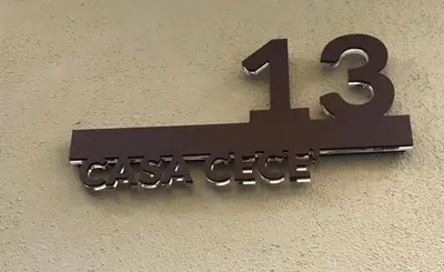 a sign on the side of a wall that reads casoncheck at CasaCecè kalsa in Palermo