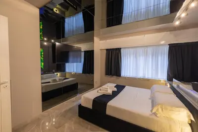 a bedroom with a large bed and a bathroom at Maximum Exclusive Suite & Spa in Palermo